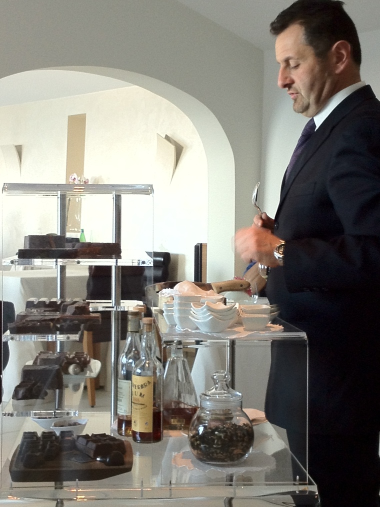 The maître offering a selection of the finest Italian, Belgium and Swiss blocks of chocolates with choice of aged rum, Armagnac, cognacs and other selected digestives.